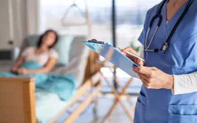 NIBA Health Insurance Products. Doctor standing by a patient in hospital room, holding clipboard.